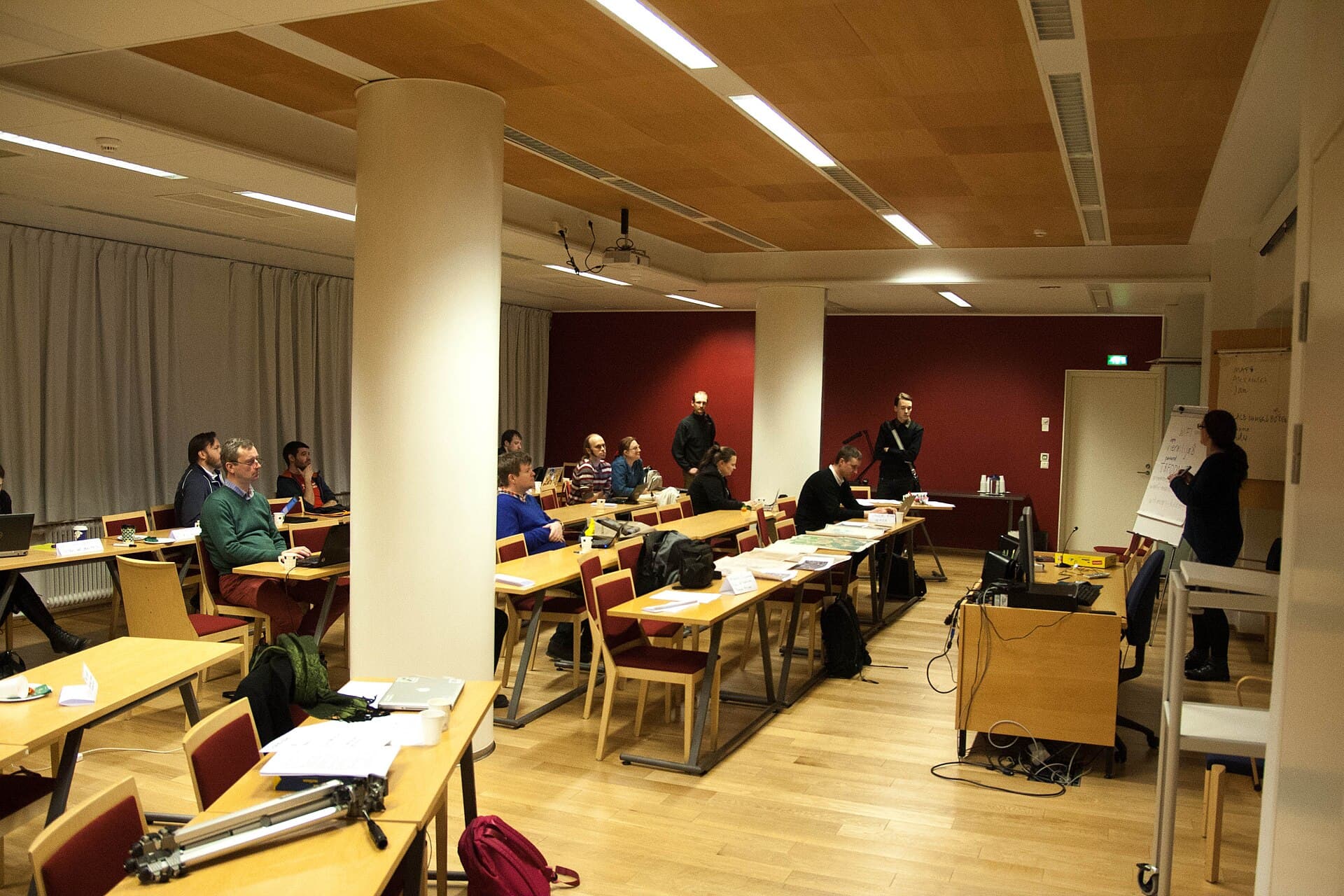 People seated at tables in a workshop meeting room