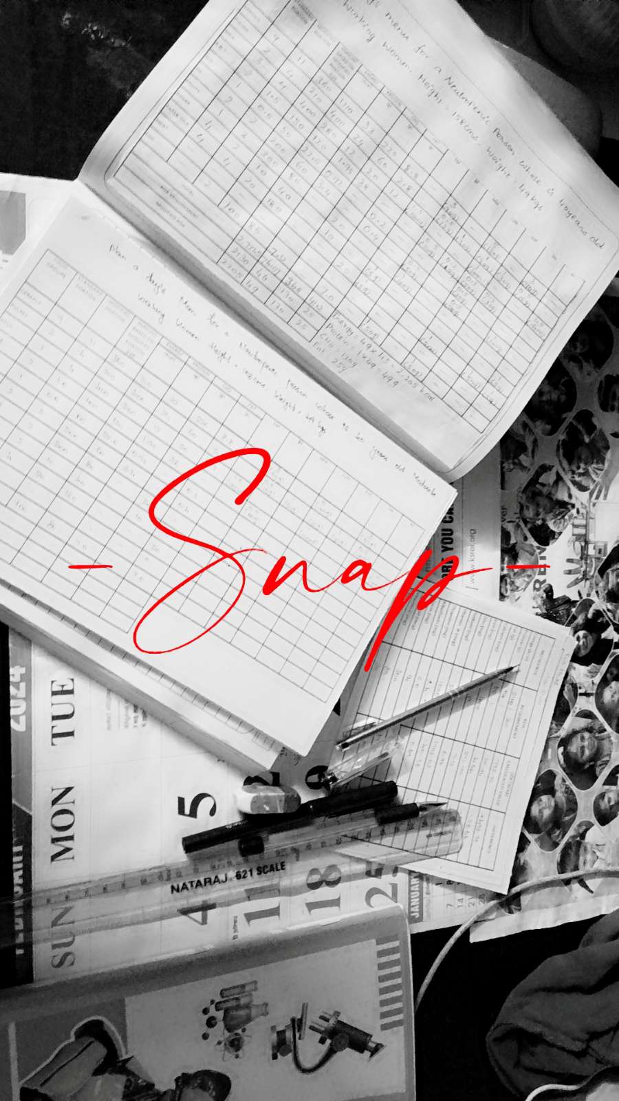 An open notebook with handwritten notes and a pen