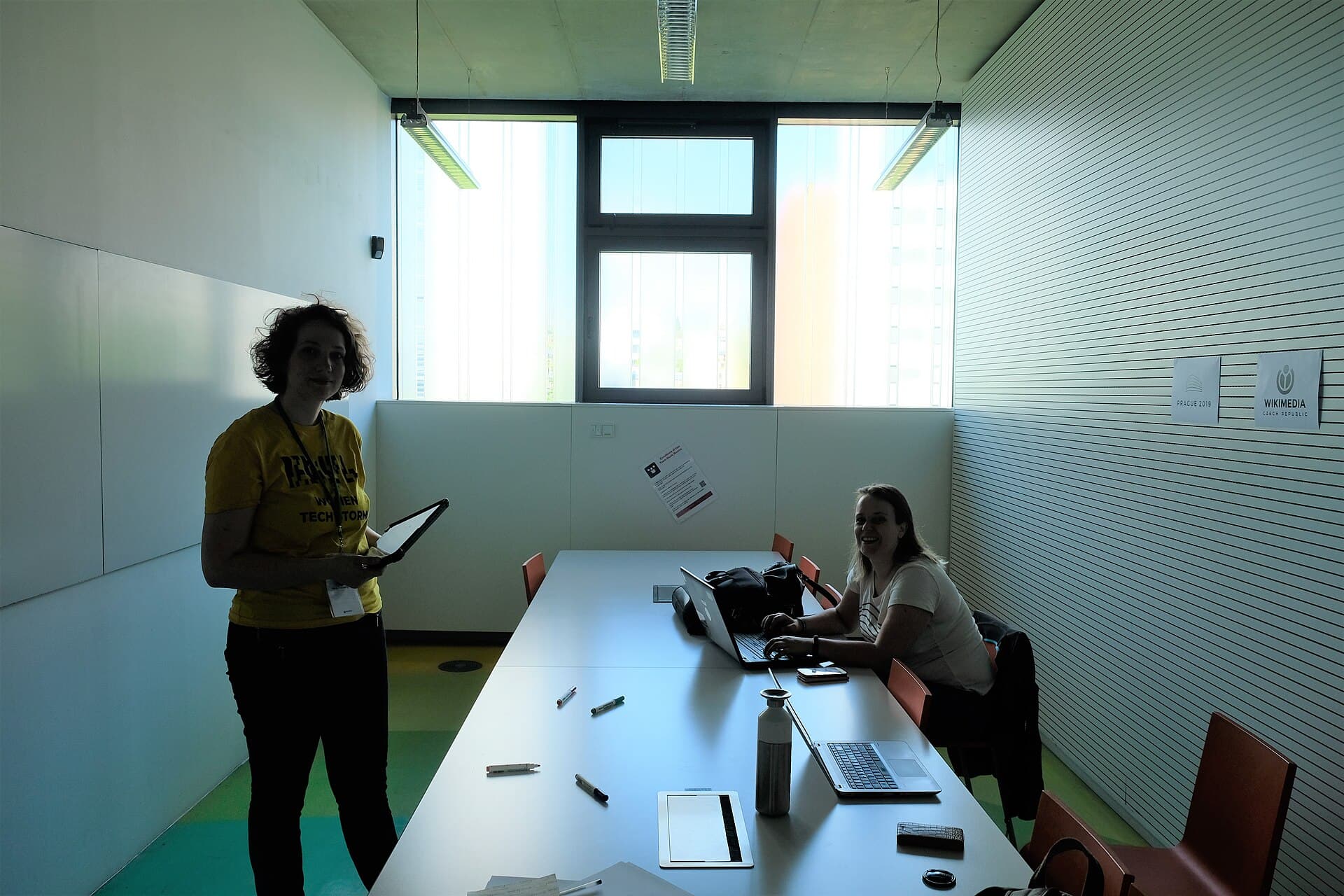 People collaborating around laptops in a workshop